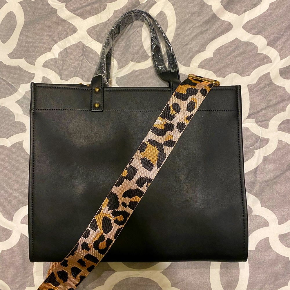 Beautiful black leather bag with large guitar strap